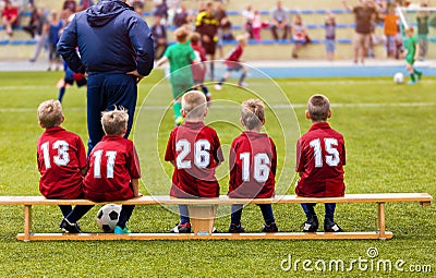 Boys Football Team Sitting on Substitution Bench. Kids School Soccer Tournament Match Editorial Stock Photo