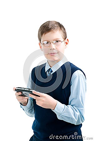 Boys hand playing portable video game Stock Photo