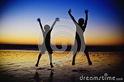 Boys Jumping on the beach Stock Photo