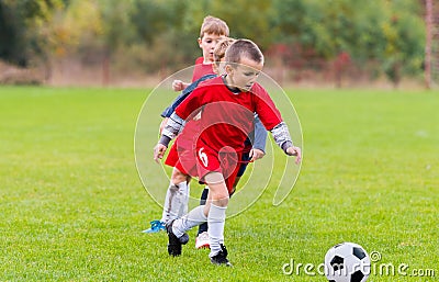 Boys kicking ball Stock Photo