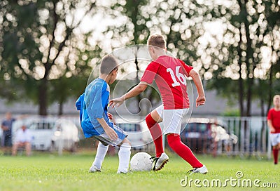 Boys kicking ball Stock Photo