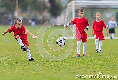 Boys kicking ball Stock Photo