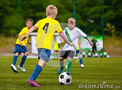 Boys Kicking Soccer Ball. Children Soccer Team. Kids Running with Ball on Football Pitch. Young Soccer Players Editorial Stock Photo