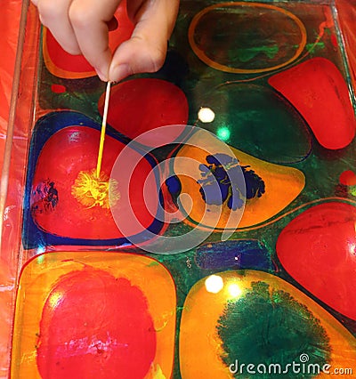 The boys are mading a bright painting with paints Stock Photo