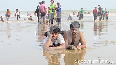 boys men people enjoying bathe sea beach waves jumping swimming Editorial Stock Photo