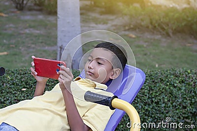 Boys play games in a mobile phone. Stock Photo