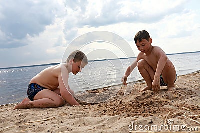 Boys play on sandy beach of Lake Seliger Stock Photo