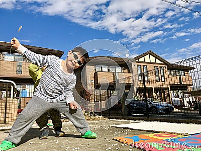 Boys Stretching Arms And Legs at Backyard with Blue Sky Background Stock Photo