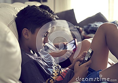 Boys playing console at home Stock Photo