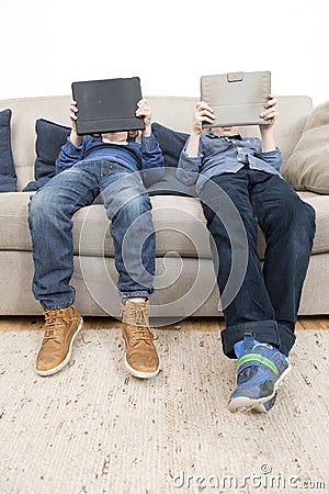 Boys playing games on a Tablet Stock Photo