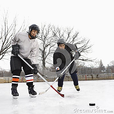 Boys playing ice hockey. Stock Photo