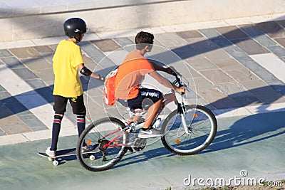 Boys with skates and bicycle in relax and sport Editorial Stock Photo