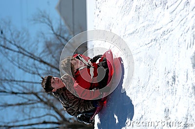 Boys sledding Stock Photo