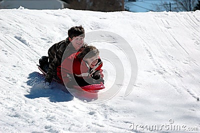 Boys sledding Stock Photo