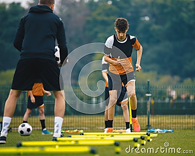 Boys' Soccer Practice Camp. Teenage boys in football training with a young coach. Teenagers on football camp Stock Photo