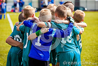 Boys` sports team huddling. Children playing sports in a team. Team sports for kids. Children sports football soccer team Editorial Stock Photo