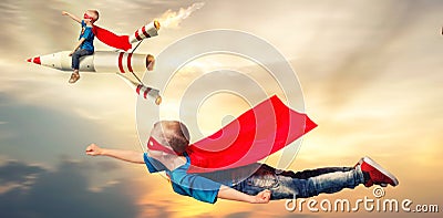 Children in superhero costumes fly and show super abilities. Stock Photo