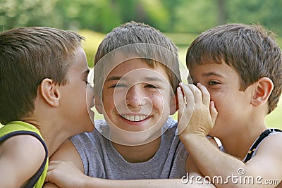 Boys Telling Secrets Stock Photo