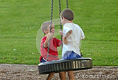 Boys on Tire Swing Stock Photo