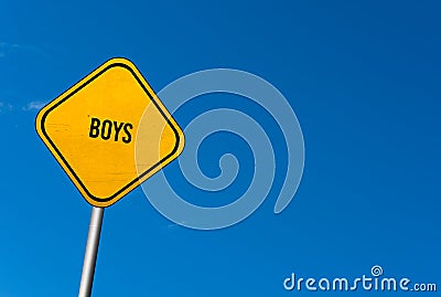 boys - yellow sign with blue sky Stock Photo