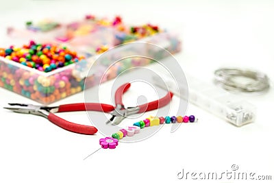 Bracelet made of plastic beads for girls unfinished in process Stock Photo