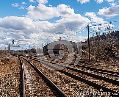 Braddock, Pennsylvania, USA March 19, 2022 Overhead railroad signals above train tracks in an industrial area Editorial Stock Photo