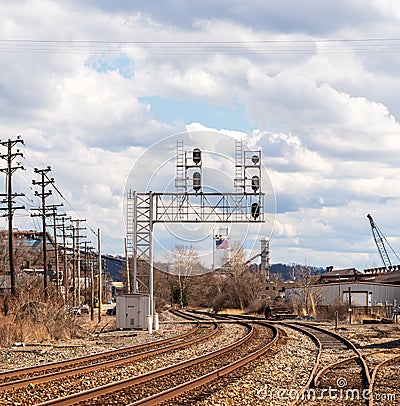 Braddock, Pennsylvania, USA March 19, 2022 Overhead railroad signals above train tracks in an industrial area Editorial Stock Photo