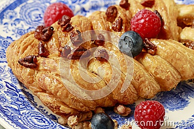 Braided danish bun made of puff pastry decorated with fresh fruits Stock Photo