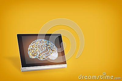 Brain on computer digital tablet on yellow background Stock Photo