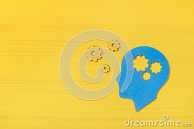 Brain works concept. Thinking, creativity concept of the human head with gears on yellow background Stock Photo