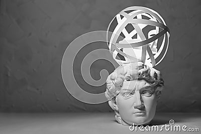 Brainstorming and idea concept - glow light bulb and abstract swirl of thoughts for solution of problem over white antique head. Stock Photo