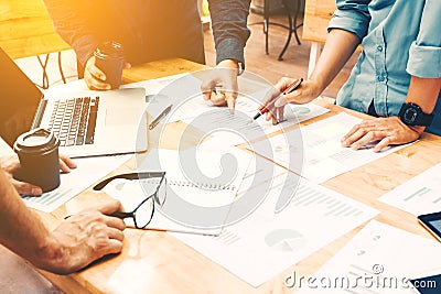 Brainstorming team of asian startup coworkers doing work on desk Stock Photo