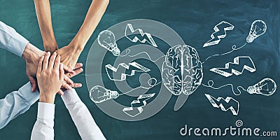 Brainstorming and teamwork concept with six hands on green chalkboard and brain hemispheres and light bulbs Stock Photo