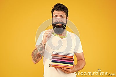 Brainy is new sexy. Educated man. Student or teacher with glasses in mouth. Smart man hold books. Brutal man borrow Stock Photo