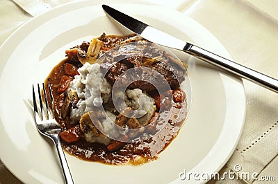 Braised beef cheeks with mushrooms and mashed purple potatoes Stock Photo