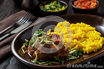 Braised veal shank, ossobuco, served with risotto and gremolata. Stock Photo