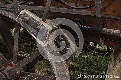 Brake of a historic agricultural vehicle, a threshing machine consisting of a wooden brake pad, steel wheel and steel actuating Stock Photo