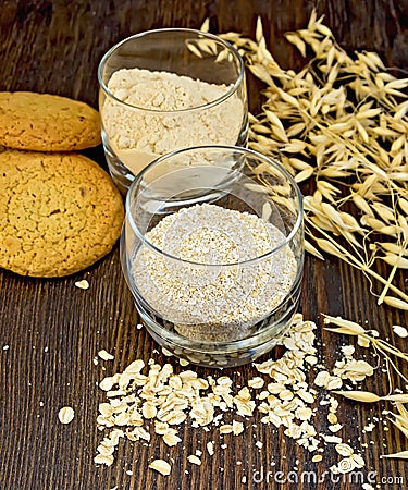 Bran and flour oat in glass with cookies on board Stock Photo