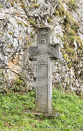 Cross with an inscription on an old Romanian standing in the inner courtyard of the Bran Castle in Bran city in Romania Editorial Stock Photo