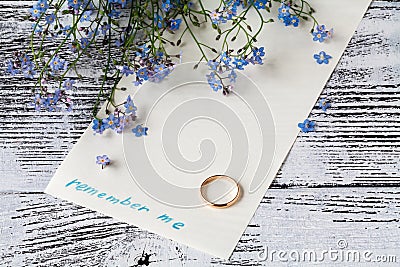 Branch of forget-me-nots on paper with phrase remember me Stock Photo
