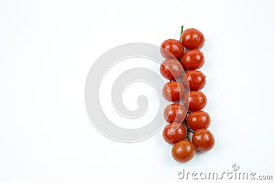 A branch of fresh red tomatoes with water drops isolated on white background Stock Photo