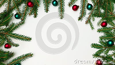 Branches of a Christmas tree border on one side on three sides with red and green balls on a white background Stock Photo