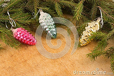 The branches of Christmas trees and fallal cone decorations on the background of wooden boards. Stock Photo