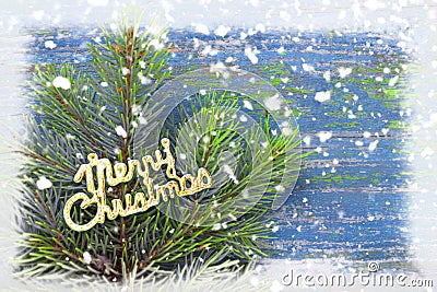 Branches of pine needles on a snowy blue wooden vintage background. Christmas and new year card. Merry Christmas Stock Photo