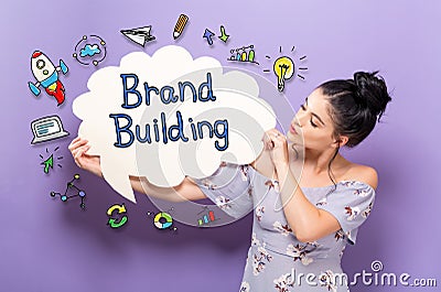 Brand Building with woman holding a speech bubble Stock Photo