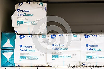 Brand name Medicom Safeguaze, non-woven sponges in white, on a supply shelf, used for medical purposes in a doctorâ€™s office Editorial Stock Photo