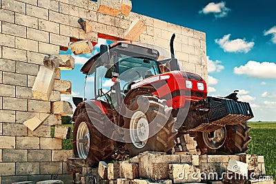 Brand new Tractor breaking through the wall Stock Photo