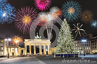 Brandenburg Gate in Berlin, with fireworks and Christmas tree Stock Photo