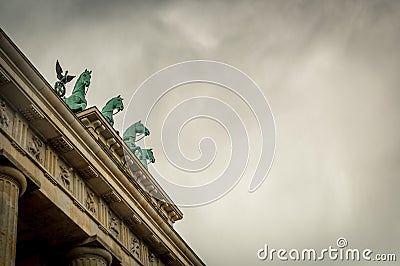 Brandenburg Gate quadriga side view under heavy dramatic sky Stock Photo