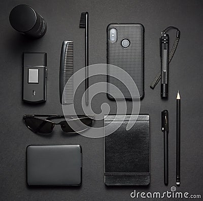 Black stylish male accessories kit on dark background. Top view Stock Photo